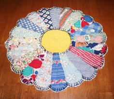 a wooden table topped with lots of different pieces of cloth