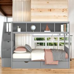 a bunk bed with drawers underneath it in a room that has wood floors and white walls