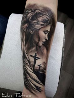 a woman with a cross tattoo on her arm