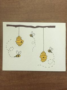 the bees are hanging from the branch with their honeycombs on it's strings