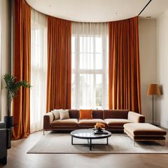 a living room with an orange drapes and two couches in front of a large window