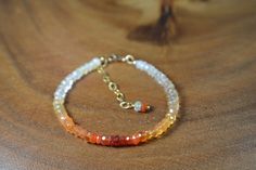 "These Gemstone Bracelets focus on the natural beauty of the featured gemstone. Made with only quality metals (sterling silver or 14k Gold Fill), the remainder of the bracelet is strictly gemstone. Delicate and Sparkly, your Loved one (or Yourself!) will absolutely fall in love with their beauty. This Gorgeous Mexican Fire Opal Bracelet is presented to you in 14k Gold. The beads are a moderate size, 4.25mm,  making for a lovely Everyday piece. The Bracelet displays the natural variety of Fire Opal in an Ombre fashion, with: soft whites, iridescent whites, yellows, oranges, and reds. In it, you will find beautiful speckles of rainbow flash. Fire Opal is associated with Abundance and Luck belongs to the Solar Plexus Chakra. It serves as the 14th Precious Stone Anniversary Gifts as well as th Fire Bracelet, Bracelet Displays, 14th Anniversary, October Birthstone Jewelry, Yellow Ombre, Mexican Fire Opal, Bracelet Display, Beads Bracelet Design, Bracelet Design