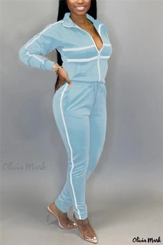 Olivia Mark - Professional Sports Blends Two-Piece Set in Blue Striped Patchwork Print, Featuring Zippered Collar and Long Sleeves Blue Activewear For Leisure In Spring, Sporty Blue Jumpsuits And Rompers For Spring, Fitted Blue Tracksuit For Sportswear, Casual Jumpsuits And Rompers For Spring Sports, Casual Spring Jumpsuits And Rompers For Sports, Blue Athleisure Tracksuit For Leisure, Blue Leisure Sportswear Tracksuit, Blue Sportswear Tracksuit For Leisure, Fitted Blue Tracksuit For Loungewear