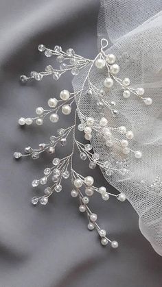 the bridal veil is adorned with pearls