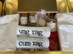 a box with towels, candles and other items in it that say vag rag cum rag