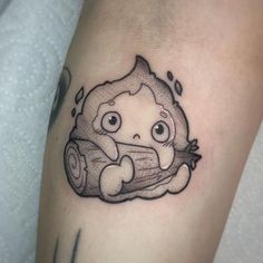 a tattoo with a cartoon character holding a piece of wood on it's arm