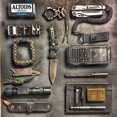 many different types of tools are laid out on a table together, including scissors and lighters