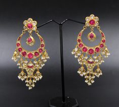 Mughal style earrings handcrafted in 22k gold, genuine untreated daimond polki slices treated ruby and fresh water pearls, Diamond slices are set with Kundan, the purest form of gold (24k). Earwires are 18k gold. Kundan-setting for gemstones is the traditional Indian style of settings. It is a unique technique that is traditional to Rajasthan and mainly practiced in Jaipur and Bikaner provinces. The process cannot be replicated with machines and is completed by three different, highly skilled craftsmen. It takes them years of dedication to learn this art. See our video to learn how these earrings were made. Though this style of jewelry is mainly made as ornate Indian bridal jewelry, we have tried to make this art form more modern. These can be worn very well with and evening gown or Indian Traditional 22k Gold Earrings With 17 Jewels, 22k Gold Meenakari Earrings For Reception, Traditional 22k Gold Earrings For Reception, Gold Ruby Chandbali Bridal Earrings, Heavy Kundan Yellow Gold Earrings, Hand Set Kundan Bridal Earrings In Yellow Gold, Yellow Gold Kundan Bridal Earrings Hand Set, Gold Chandbali Bridal Earrings With Ruby, Diwali Bridal Earrings In 22k Gold