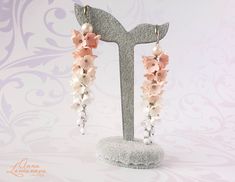 "Peach bridal earrings Peach bridesmaid earrings Flower long earrings Bridal floral earrings Bridesmaid jewelry gift Peach wedding jewelry Wedding long earrings with flowers lilac, and supplemented with glass beads. White Peach earrings for Bride. This bridal earrings is handmade. Perfectly adorns a range of wedding dresses These beautiful earrings are perfect for bridesmaids. And also for any celebration. Lilacs, made of polymer clay. For these flowers I used high quality polymer clay. Each flower is made by hand in a special technique. Length of the earrings with hooks approx 9,4 см / 3.70\" ✿ These earrings are ready to ship! ✿ Real colors may slightly differ from one monitor to another, as it depends on specific monitor settings. ✿All my jewelry packed in a gift box ♥ Thank you for vis Delicate Dangle Flower Earrings For Bridesmaids, Handmade Flower Chandelier Earrings For Wedding, Handmade Rose Gold Bridal Earrings For Wedding, Elegant Handmade Flower Earrings For Bridesmaids, Handmade Feminine Wedding Earrings, Handmade Feminine Earrings For Wedding, Rose Gold Jewelry With 3d Flowers For Wedding, Pink Dangle Flower Earrings For Wedding, Delicate Pink Flower Earrings For Wedding