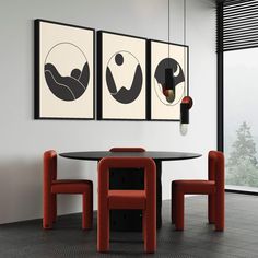 a dining room table with chairs and art hanging on the wall above it, along with two framed pictures