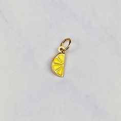 "A beautiful 14K yellow gold 3D Lemon slice pendant charm with baked yellow enamel. It has a soldered ring to attach to a bracelet or a necklace. The very delicate pendant measures 7mm tall by 4mm wide. It can be used as a necklace pendant or a bracelet charm and would make a perfect gift. The pendant can be paired with a shiny 14K Yellow Gold 1.2mm cable link chain in either 16\" or 18\" length or with a 16\" 14K gold-plated cable link chain. All items are packaged ready to be gifted. Unless re Hypoallergenic Gold Enamel Jewelry, Dainty Yellow Gold Charms With Lobster Clasp, Yellow Gold Enamel Charms For Gift, Handmade Yellow Gold Charms For Gifts, Handmade Gold Charm Necklace With Enamel, Handmade Yellow Gold Pendant Charms, Handmade Yellow Gold Charms As Gifts, Handmade Gold Charm Necklaces With Enamel, Yellow Gold Enamel Round Pendant Charm Necklace