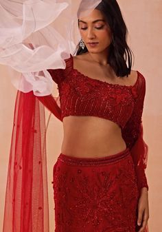 Elevate your festive wardrobe with the Red Embroidered Fishcut Lehenga Set, crafted from luxurious Satin Georgette. The stunning red lehenga features a graceful fishcut silhouette adorned with statement floral motifs that exude elegance and sophistication. The accompanying 3D floral blouse is a work of art, with intricate embroidery that adds depth and texture, making it a standout piece. Completing the ensemble is a beautifully draped dupatta, adding a touch of traditional charm. Perfect for a bride or bride-to-be on your special day. Composition : Lehenga, Blouse & Dupatta : Satin Georgette Care: Dry Clean Only and Vacuum Storage This product can be customized for sleeves, length and colour Delivery : 4-6 weeks as the product is hand crafted. Check Size Guide or choose MySize for free cu Red Party Wear Lehenga With Intricate Embroidery, Red Georgette Lehenga With Unstitched Blouse, Red Sharara With Intricate Embroidery For Party, Red Floral Embroidered Sharara For Party, Festive Red Pre-draped Saree With Floral Embroidery, Red Floor-length Sharara With Unstitched Blouse, Red Fitted Pre-draped Saree With Intricate Embroidery, Red Semi-stitched Lehenga With Unstitched Blouse, Red Party Wear Sets With Unstitched Blouse