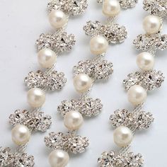 This beautiful trim is made of high-quality clear rhinestones. It is perfect for all special occasions. It can be used for wedding dress, wedding belts and sashes, bridesmaid sashes and belts hats, headbands, headpieces, flower bouquet wrap, wedding invitation, gowns, hair accessory, sash craft, jewelry, cake decoration, bags, scrapbook or any other decorations. Applying Method: Sew on, Glue on Color: silver Gold Size: Width: 3/4 Inches Length: 1 Yard Please contact us for wholesale quantities a Elegant Embellished Crystal Bridal Belt, Glamorous Wedding Bridal Belt With Crystals, Elegant Crystal Backdrop Necklace With Rhinestones, Silver Crystal Bridal Belt For Wedding, Elegant Crystal Embellished Rhinestone Necklace, Elegant Embellished Crystal Rhinestone Necklace, White Rhinestone Bridal Belt For Evening, Elegant Embellished Rhinestone Necklace For Wedding, Crystal Bridal Necklace With Rhinestones For Wedding