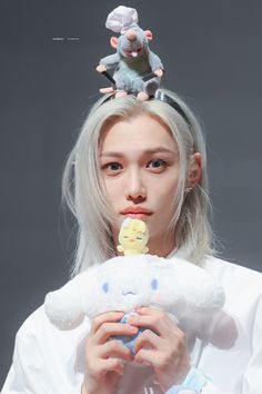 a woman holding a stuffed animal in front of her face