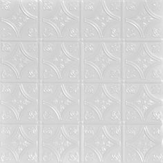 a white tile wall with many different shapes and sizes