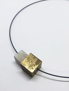 minimalist modern necklace in black stainless steel with 2 cubes of concrete. An element was processed with gold paint. All pieces of jewelery are designed and cast in our studio in the south of Hesse. The extra fine concrete is especially suitable for exclusive pieces of jewelry. The concrete pieces are processed in their natural state (unhoned and polished). Each chain is thus individual and unmistakable. Handmade in the style of CA.ON.IS. BAGS Choker circumference 40cm Lock for turning design & made in germany Minimalist Brass Square Pendant Jewelry, Minimalist Brass Necklace With Square Pendant, Minimalist Adjustable Square Pendant Necklace, Concrete Minimalist, Gold Concrete, Choker Chain Necklace, Concrete Jewelry, Modern Necklace, Choker Chain