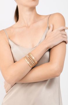 Get a trendy stacked look with this gleaming cuff bracelet finished in shiny 14-karat gold plate. 1 1/2" width 14k-gold plate Imported Gold Metal Wrap Bracelet Bangle, Gold Stackable Wrap Bracelet, Gold Stackable Wrap Bracelet Bangle, Stackable Metal Cuff Bracelet For Party, Elegant Gold Metal Wrap Bracelet, Modern Gold-tone Gold Plated Cuff Bracelet, Gold Cuff Bracelet For Party With Jubilee Style, Chic Yellow Gold Cuff Jewelry, Gold Jubilee Bracelet For Party