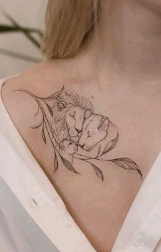 a woman's chest with a lion and flower tattoo on her left side shoulder