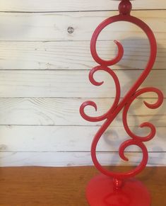 a red candle holder on a wooden table