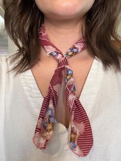 a woman wearing a neck tie with flowers on it