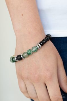 An earthy assortment of shiny black beads, glassy green stone beads, glistening silver accents, and a single black lava rock bead are threaded along a stretchy band around the wrist for a refreshing look.

Sold as one individual bracelet. Bracelets Trendy, Peace Bracelet, Lava Bead Bracelet, Lava Rock, Paparazzi Accessories, World Peace, Paparazzi Jewelry, Brass Earrings, Silver Accents