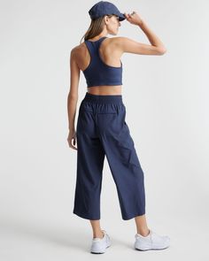 These look like classic work pants, but move like your favorite activewear. Our cropped Performance Tech Wide Leg Commuter Pants have just the right amount of stretch for days when you’re on the go, plus the sun protection and quick-dry properties of top-notch performance wear. And they look great with sneakers.  | Quince | Women's Performance Tech Wide Leg Pants in Navy, Size XS, Recycled Polyester Functional Elastane Pants For Gym, Functional Elastane Gym Pants, Athleisure Elastane Pants With Moisture-wicking, Athleisure Moisture-wicking Elastane Pants, Functional Elastane Workout Pants, Sportswear Bottoms With 4-way Stretch, Sporty Activewear With Functional Drawstring Long Pants, Casual Moisture-wicking Elastane Activewear, Versatile Sports Activewear With Elastic Waistband