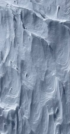 an aerial view of snow covered mountains and valleys in the distance, taken from space