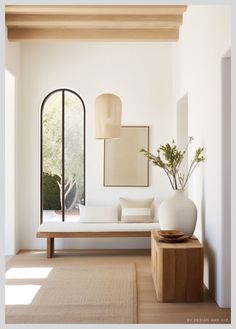 a living room filled with furniture and a large mirror on the wall next to it