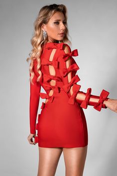 Turn heads in this red, long-sleeved, body-hugging mini dress with intricate butterfly cutouts and a charming bow detail. Its bold design and seductive allure make it the perfect choice for a night out on the town or a special date night. Handmade customization Fabric composition: 90% polyester fiber, 10% spandex Washing method: hand wash or dry clean Popular elements: bow Long Sleeve Cutout Bodycon Dress For Party, Party Mini Dress With Cutout And Long Sleeves, Party Long Sleeve Cutout Mini Dress, Long Sleeve Cutout Mini Dress For Party, Long Sleeve Cutout Dress For Party, Long Sleeve Mini Dress With Cutout For Cocktail, Holiday Long Sleeve Dress With Bow, Chic Red Mini Dress With Bow, Glamorous Red Long Sleeve Bodycon Dress