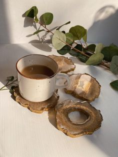 a cup of tea next to two pieces of driftwood