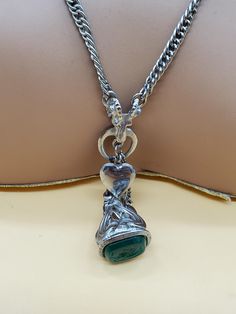 In good used vintage condition.  The silver tone chain is slightly twisted because that's the way it was made. Unknown maker.  Very unique looking.  Silver tone metal with dangling small lockets that actually open and a fob with a green end. Please look at the pictures for details and condition because the exact item pictured is the exact item that you will receive. Vintage Silver Charm Necklace With Locket, Vintage Silver Locket Charm Necklaces, Vintage Silver Locket Charm Necklace, Vintage Pendant Chain Necklace Nickel Free, Vintage Silver Pendant Charm Necklaces, Vintage Silver Pendant Charm Necklace, Vintage Silver Charm Necklaces, Silver Metal Chain Necklace With Vintage Charm, Vintage Sterling Silver Chain Necklace