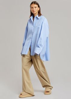 Color: White/Light Blue Lightweight shirting fabric Oversized fit Pointed collar Single breast pocket High-low curved hem Button front closure 100% Cotton Dry Clean By The Frankie Shop. Imported Product Measurements: XS/S - 24" Shoulder, 56" Bust, 31" Length M/L - 25" Shoulder, 59" Bust, 31.5" Length Model is 174cm/ 5'8" wearing size M/L Denim Projects, Shirting Fabric, The Frankie Shop, Frankie Shop, Top Design Fashion, Stripe Shirt, Work Wear Women, Cut Shirts, Striped Shirt