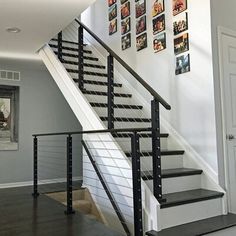 there is a stair case with pictures on the wall