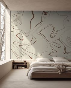 a large bed sitting in a bedroom next to a wall with abstract designs on it