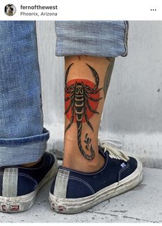 a person with a scorpion tattoo on their foot and the bottom half of his leg