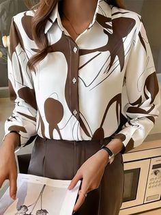 Long Sleeve Stand Collar Button Printed Blouse Upgrade your wardrobe with the MsDressly® Abstract Artist Printed Long Sleeve Button-Up Top. This stunning blouse is designed to captivate with its unique abstract print in brown, offering a blend of casual and fashion-forward style. Key Features: Long sleeves for added coverage and style Elegant stand collar for a refined look Chic button-up design for versatility Made from 100% polyester for a lightweight feel Easy care instructions: Hand wash col Brown Graphic Print Button-up Top, Brown Blouse With Buttons For Workwear, Brown Buttoned Blouse For Work, Brown Buttoned Top For Office, Long Sleeve Blouse With Abstract Print For Work, Graphic Print Blouse For Office In Fall, Graphic Print Office Blouse For Fall, Abstract Print Patterned Tops For Workwear, Workwear Long Sleeve Blouse With Abstract Print