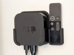 an apple tv sitting on top of a charger