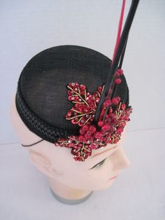 "* Designed on a black Sinamay pillbox hat form this hatinator will take you anywhere you want to go and will catch many eyes. The design includes a wide black leather braided trim complemented by handmade red sequen and bead worked Maple Leaves. To add a touch more of detail shiny red berries look good enough to eat. * The three black and red quills give dramatic height to the piece and upon ordering this is the exact fascinator you will receive. * With a hat diameter of 5.5\" it qualifies as f Vintage Black Fascinator For Party, Black Short Brim Party Headpiece, Black Short Brim Headpiece For Party, Black Top Hat With Structured Crown For Party, Vintage Black Headpieces For Parties, Adjustable Cap Headpiece For Party, Adjustable Cap Style Headpiece For Party, Formal Black Mini Hat With High Crown, Adjustable Black Headpieces For Races