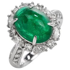 This exquisite GIA Genuine Emerald & Diamond Cocktail Ring is expertly crafted in solid platinum with a total weight of 9.54 grams. The emerald with a weight of approx. 5.17 carats are surrounded by (6) round cut and (6) marquise cut genuine natural diamonds,  (12) round-cut genuine natural diamonds placed on either side of the ring. All  G-H color, and VS clarity forming a dazzling oval halo, The top of this piece measures 17 mm x 22 mm, 10 mm (height) currently US ring size 4.75 and sizable. W Luxury Oval Emerald Birthstone Ring, Green Oval Emerald Ring In Platinum, Luxury Marquise Emerald Ring, Luxury Emerald Ring With Oval Cabochon And 17 Jewels, Luxury Oval Cabochon Emerald Ring With 17 Jewels, Exquisite Oval Emerald Ring In Platinum, Platinum Oval Emerald Ring With 17 Jewels, Oval Platinum Emerald Ring With 17 Jewels, Elegant Oval Platinum Emerald Ring With Halo Setting