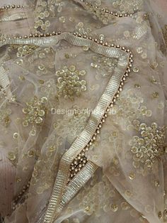 This is a Dupatta made on orders. It is made using golden color net fabric with gold sequine embroidery all over. We stitch a beautiful golden lace to all sides of it and decorate with tassels. Dupatta is having a length of 100 inches and width of around 40 inches. I don't keep it readymade I only make it exclusively for my customers. Can be fully customised. Floor-length Sequin Fabric For Diwali, Festive Floor-length Sequined Sharara, Dola Silk Lehenga With Mirror Work For Eid, Wedding Sharara With Sequins, Traditional Sequined Wedding Wear, Gold Anarkali Set With Gota Work For Party, Gold Floor-length Sets With Dabka Work, Gold Anarkali Set With Mirror Work For Diwali, Festive Sequined Dola Silk Traditional Wear