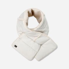 What's better than a cozy scarf? A cozy scarf you can wear in multiple ways. The AW UGG®fluff Rev Scarf is a pull-through scarf made from super soft materials. Style it with the outer smooth shell or reverse it to show the plush fleece UGG®fluff lining. | Reversible scarf. Quilted Shell - 100% Recycled Nylon. Plush Fleece Lining and Trim - 100% Polyester. Fill - 100% Recycled Polyester. 50 inch L X 9 inch W. Leather label with Graphic UGG® Font. Imported. | UGG® Women's AW UGG®fluff Rev Scarf Nylon/Fleece/Recycled Materials Scarves in Nimbus Casual Cream Scarves For Winter, Casual Cream Scarf For Winter, Ugg Fur Blanket, Ugg Classic Rising Toggle, Ugg Scarf, Cream One-size Winter Scarves, Faux Fur Scarf, Reversible Scarf, Cozy Scarf