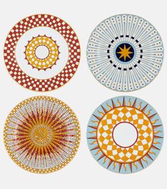 four plates with different designs on them