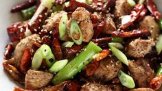 a white bowl filled with meat and vegetables