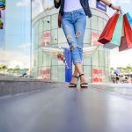 a woman is walking down the street with shopping bags