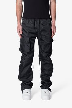 the Snap Front Cargo Pants are designed with a relaxed fit throughout, with cargo pockets at the side seam, snap closures at the outseam with a zipper underneath from the knee down, velcro closure at the leg opening and finished with a tonal cotton drawcord. details relaxed fit 100% nylon snaps and zipper at outseam model is 6’1, 140 lbs and wears a size 30