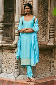 Aqua blue straight kurta with placement hand embroidered buttis. Paired with a churidar and matching hand embroidered dupatta.
Components: 3
Pattern: Hand Embroidery
Type Of Work: Floral
Neckline: Round Neck
Sleeve Type: Sleeveless
Fabric: Dupion Silk, Pure Silk
Color: Blue
Other Details: 
 Model height: 5ft 9inches, wearing size XS
Length:
Kurta: 42 inches
Churidar: 40 inches
Occasion: Sangeet - Aza Fashions Satin Embroidery, Kurta Set For Women, Ritu Kumar, Embroidered Dupatta, Dupion Silk, Straight Kurta, Satin Color, Sequins Embroidery, Churidar