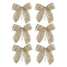 four gold bows with white ribbons on them