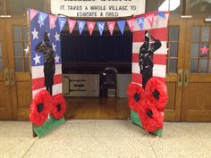 two red poppies in front of an american flag arch