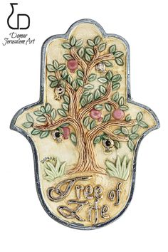 a ceramic hamsa with an apple tree and the words, god's eye