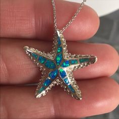 This Beautiful Opal Star Fish 925 Sterling Silver Pendant / Chain Is 6 Grams In Weight. The Chain Is 18” Inches In Length. The Star Fish Is 1” In Length. It’s Stamped 925 Sterling Silver. Please Check All Pictures For Details. White Gold Sterling Silver Starfish Jewelry, Silver Starfish Charm Pendant Jewelry, Blue Sterling Silver Necklace With Starfish Charm, Blue Sterling Silver Necklaces With Starfish Charm, Sterling Silver Starfish Charm Pendant Necklace, Silver Starfish Charm Necklace In Sterling Silver, Star-shaped Sterling Silver Jewelry With Lobster Clasp, Sterling Silver Pendant Necklace With Starfish Charm, Silver Sterling Necklace With Starfish Charm